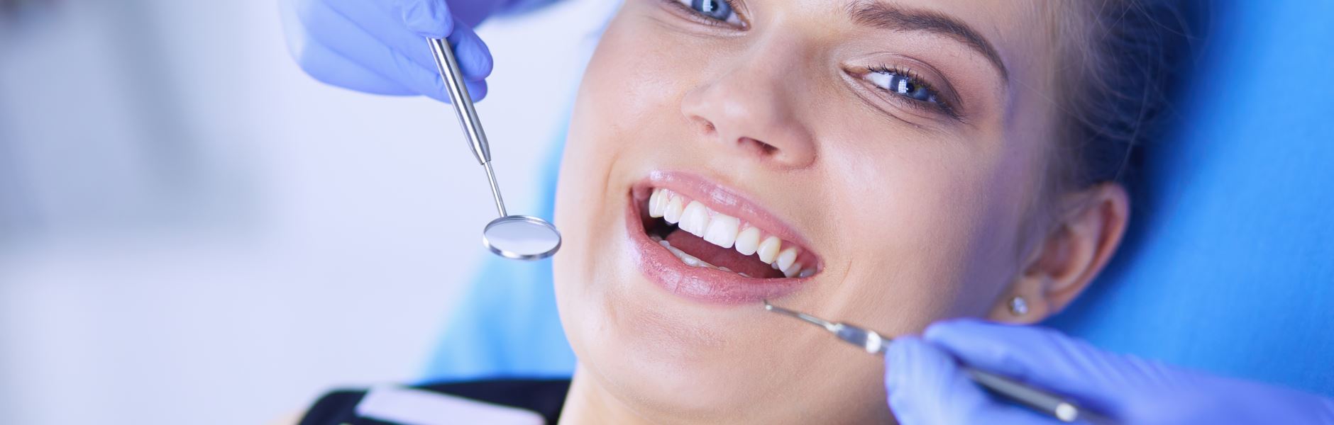 A beautiful woman is smiling after dental bonding