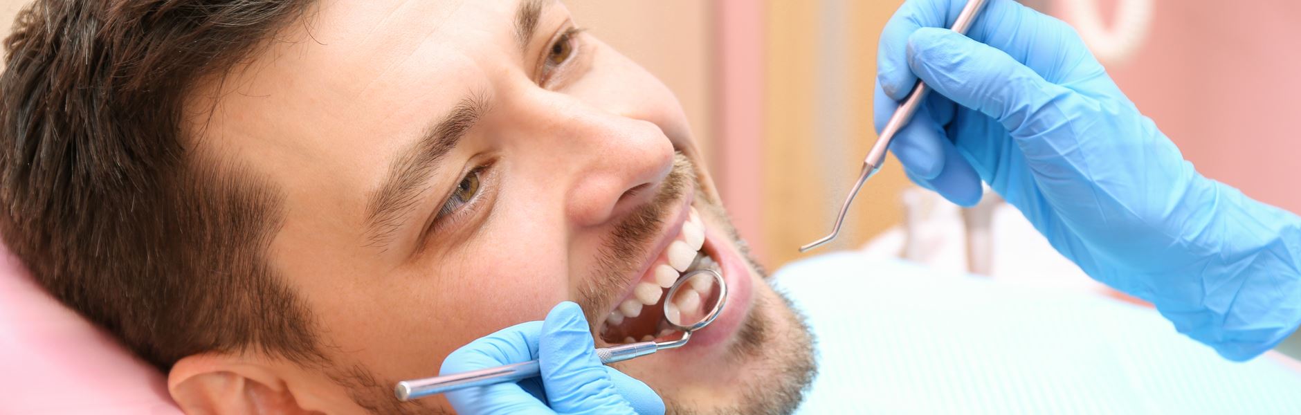 Dentist examining patient's teeth after Porcelain Bridges treatment